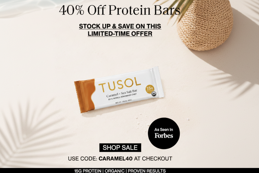 Promotional graphic for Tusol Caramel + Sea Salt protein bars, showing one wrapped bar on a light cream background with sale text, a black 'As seen in Forbes' badge, and caramel pieces as props.